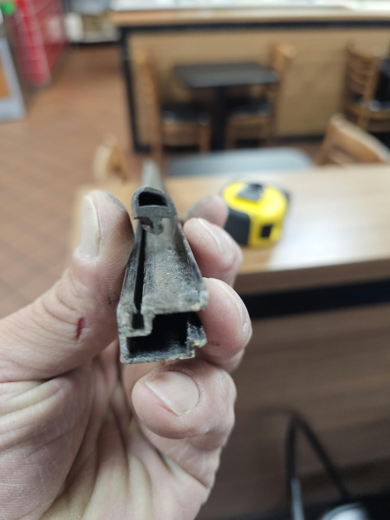 The worn glazing gasket pulled from the door: hardened, shrunk and no longer sealing