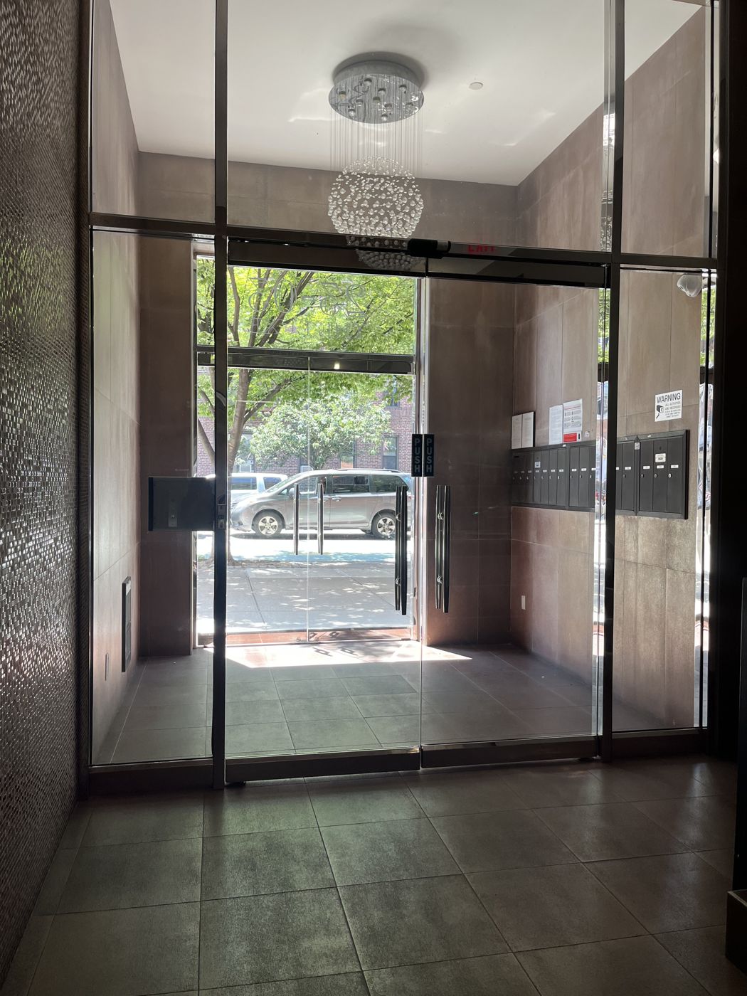 Glass vestibule doors in an apartment building lobby in Astoria, Queens