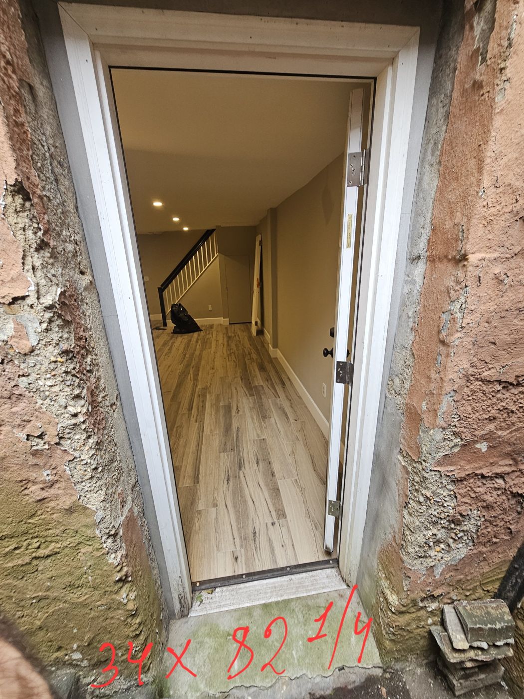 Existing door opening marked 34 by 82 and a quarter inches