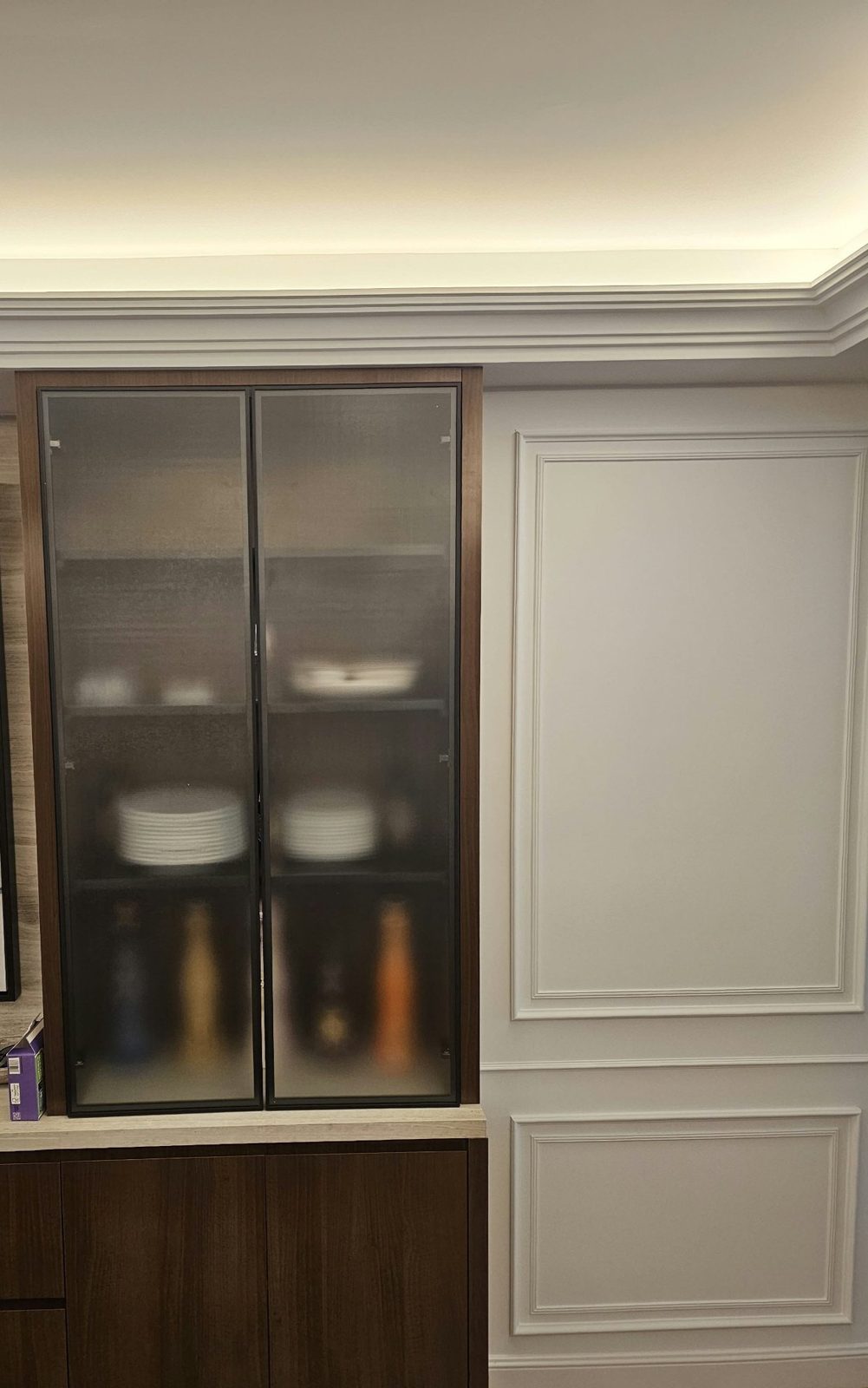 Pair of custom slim black aluminum cabinet doors with translucent decorative glass in a built-in wood cabinet at 135 East 83rd Street, Manhattan