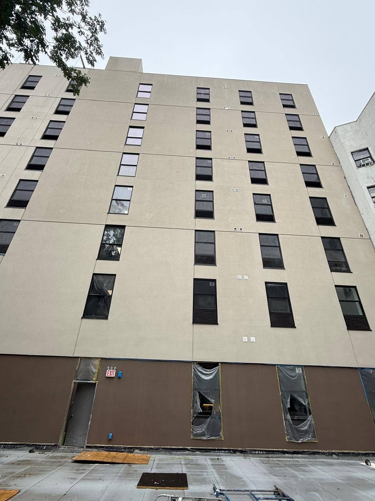Rear elevation of 1763 Amsterdam Avenue, Manhattan, with dark-framed Crystal windows on every floor