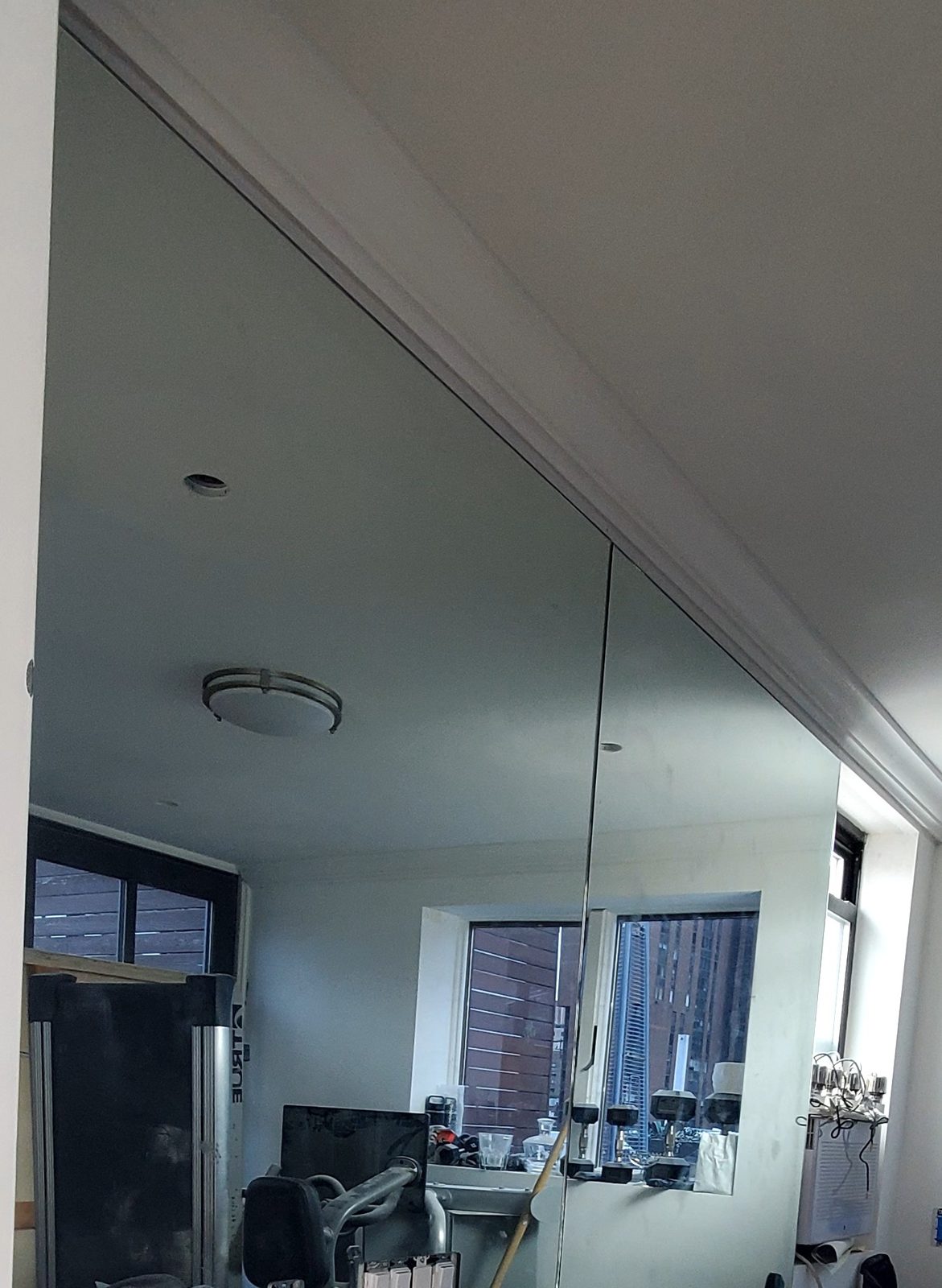Wall mirror in two panels with a vertical joint on the gym room wall of the 300 East 90th Street penthouse