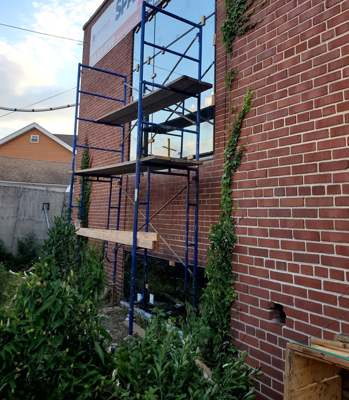 Scaffold at the side elevation of 3915 Flatlands Avenue, Brooklyn, during window and curtain wall installation