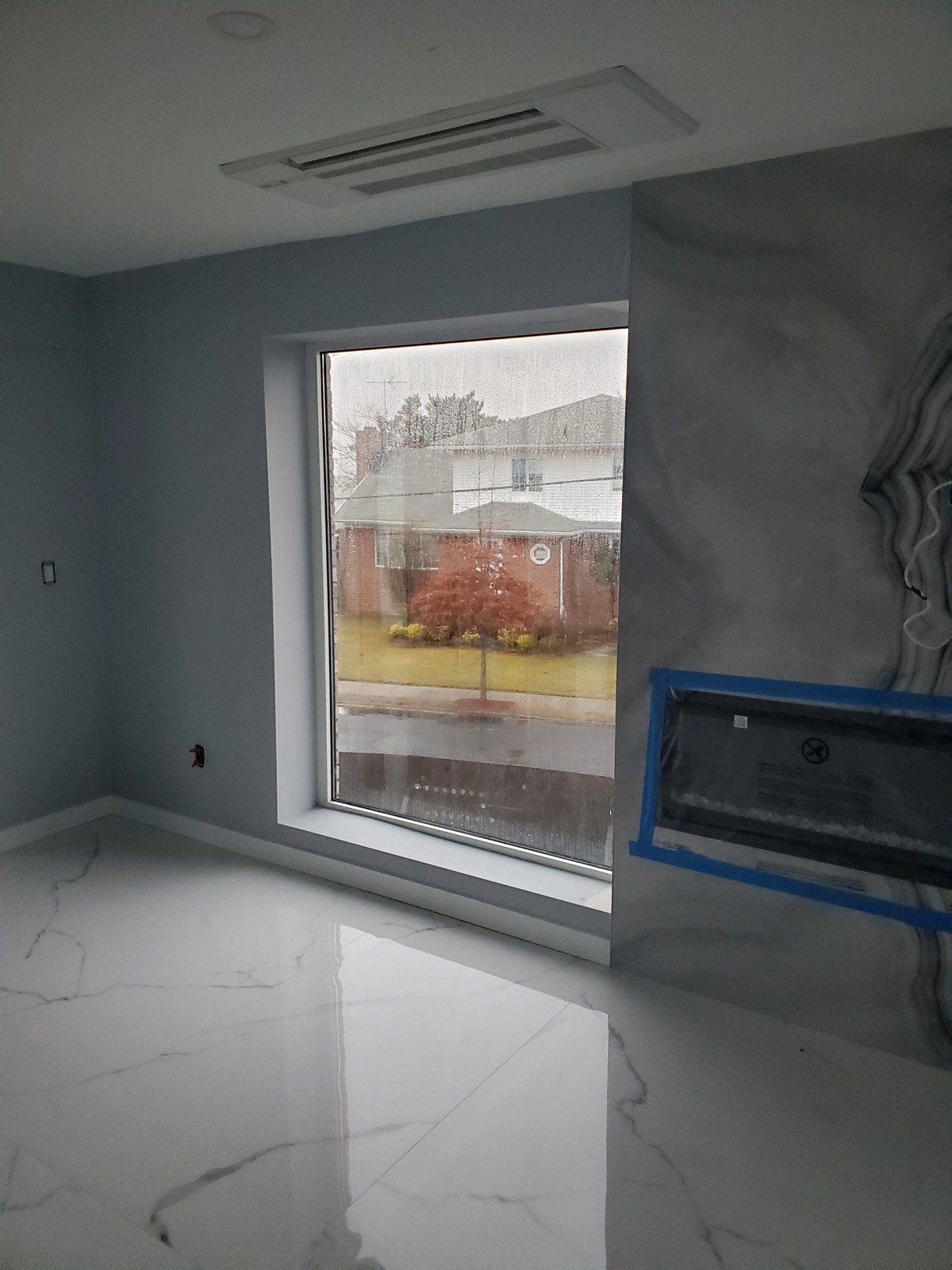 Large fixed Alutech aluminum picture window with gray Solarban 60 glass in a deep reveal at 5101 Beach 51st Street, Sea Gate