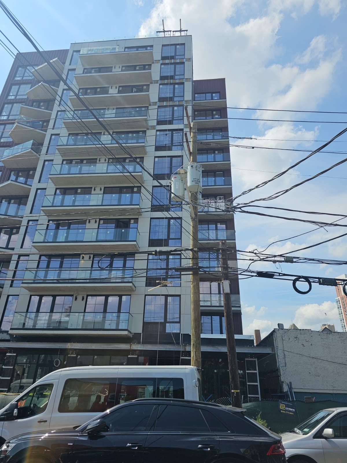 New building at 66 McWhorter Street, Newark, NJ, with an aluminum storefront at street level and uPVC windows on the floors above