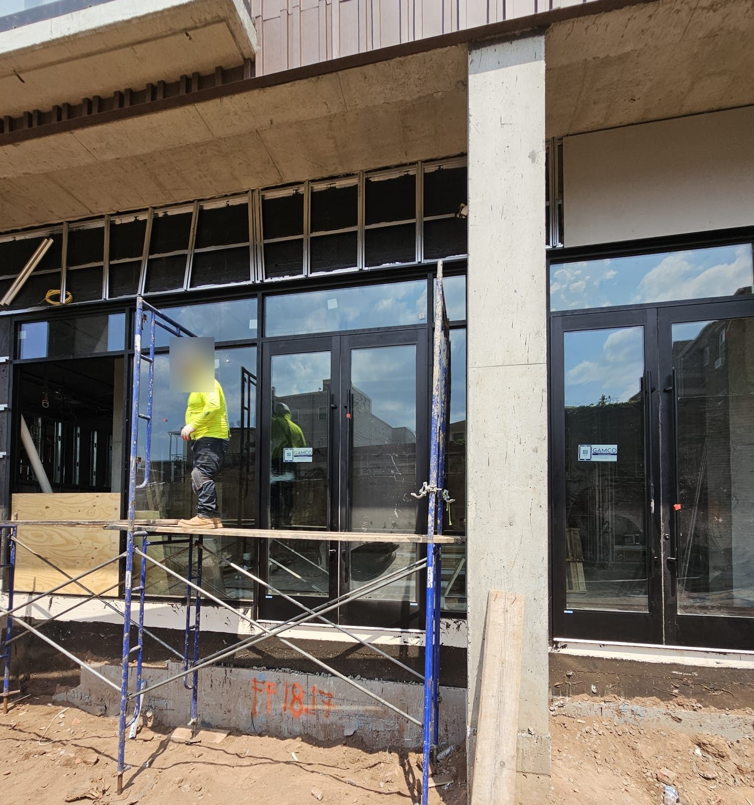 Two pairs of aluminum storefront doors during installation at 66 McWhorter Street, Newark