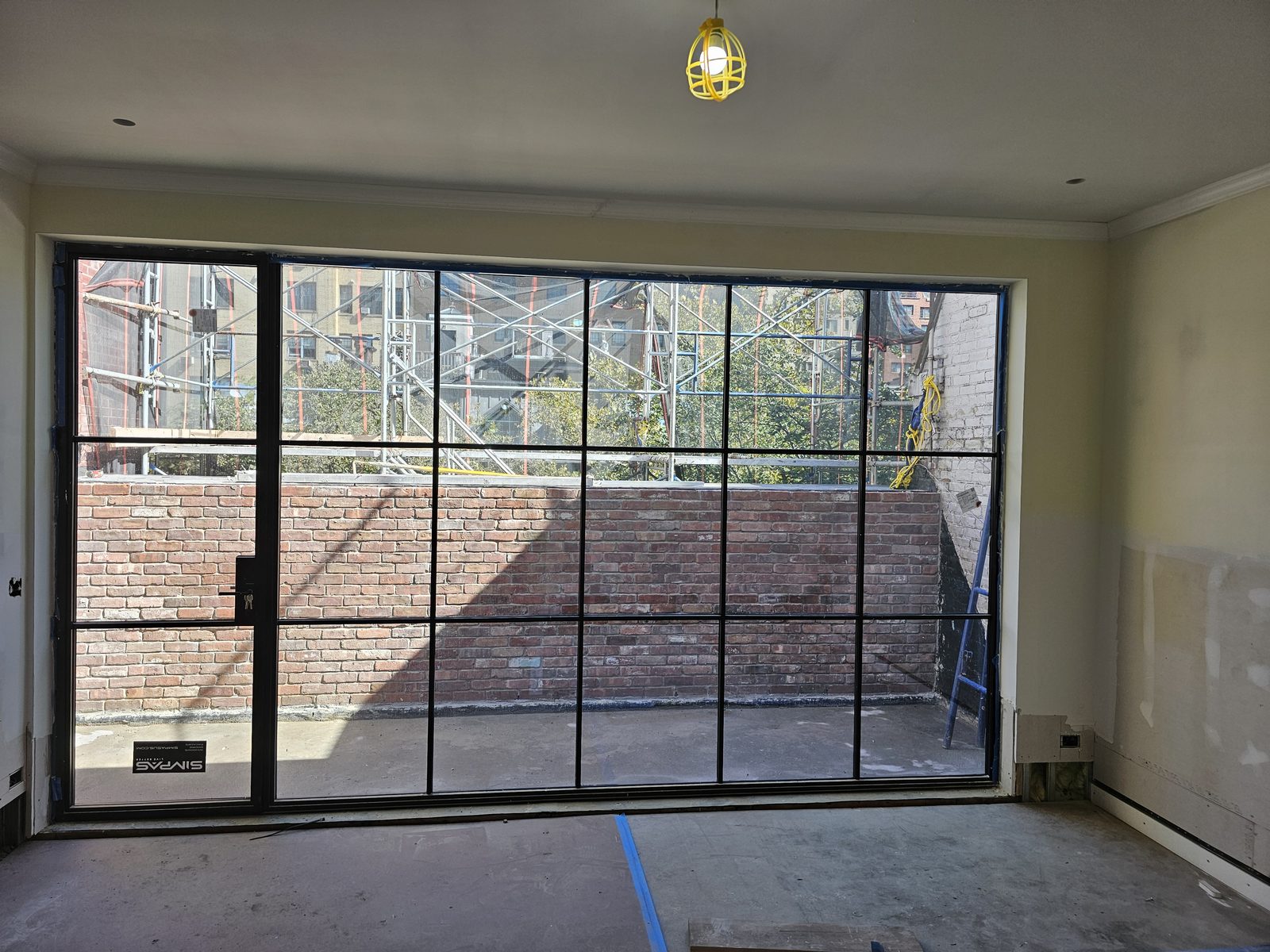 Black divided-lite SIMPAS in-swing door on the top floor opening onto a terrace, East 71st Street