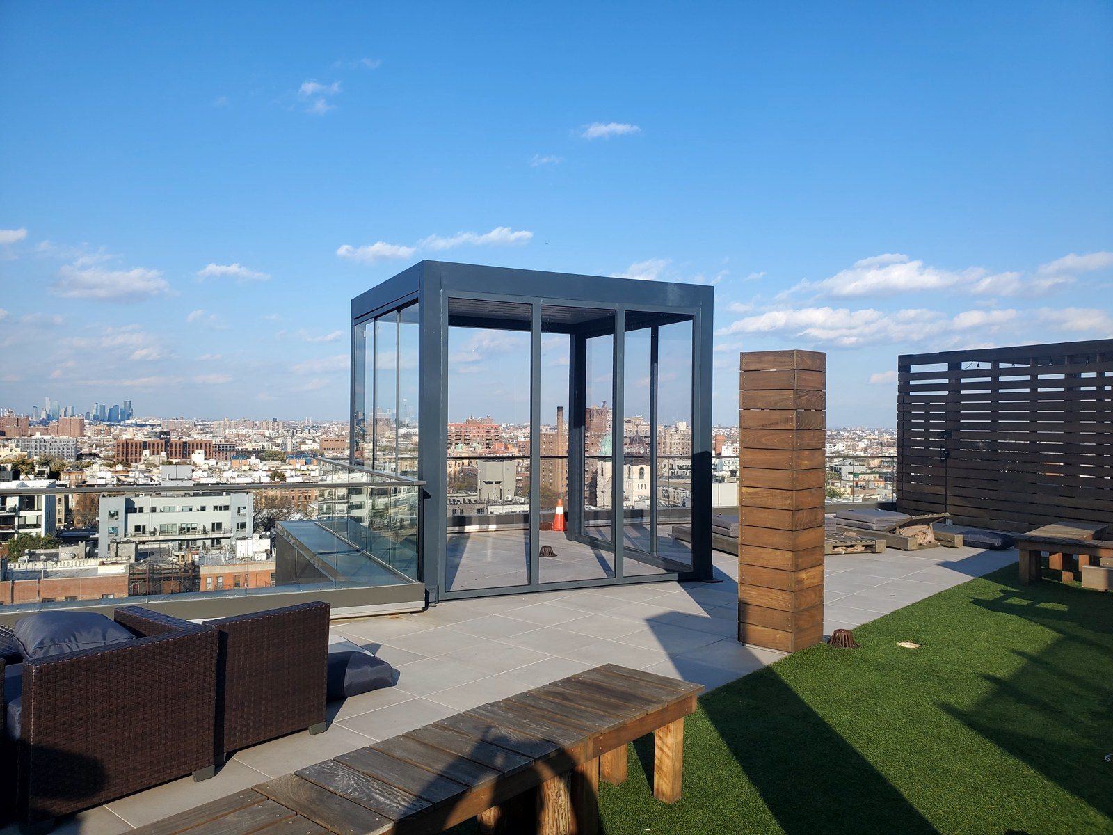 Rooftop pergola sunroom on the terrace at 86 Washington Avenue, Brooklyn, with the city skyline beyond