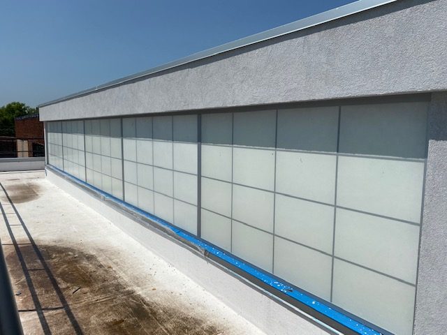 Kalwall translucent panels with a rectangular grid pattern along the roof at 96 Ingraham Street, Brooklyn