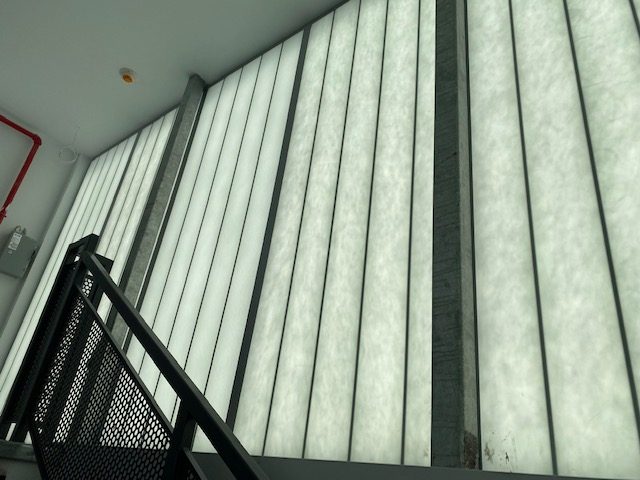 Kalwall translucent panels seen from the stair inside 96 Ingraham Street, Brooklyn