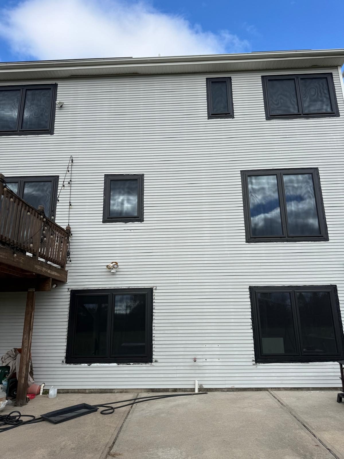 Rear elevation of the house in Somerset, NJ with black aluminum windows on three levels