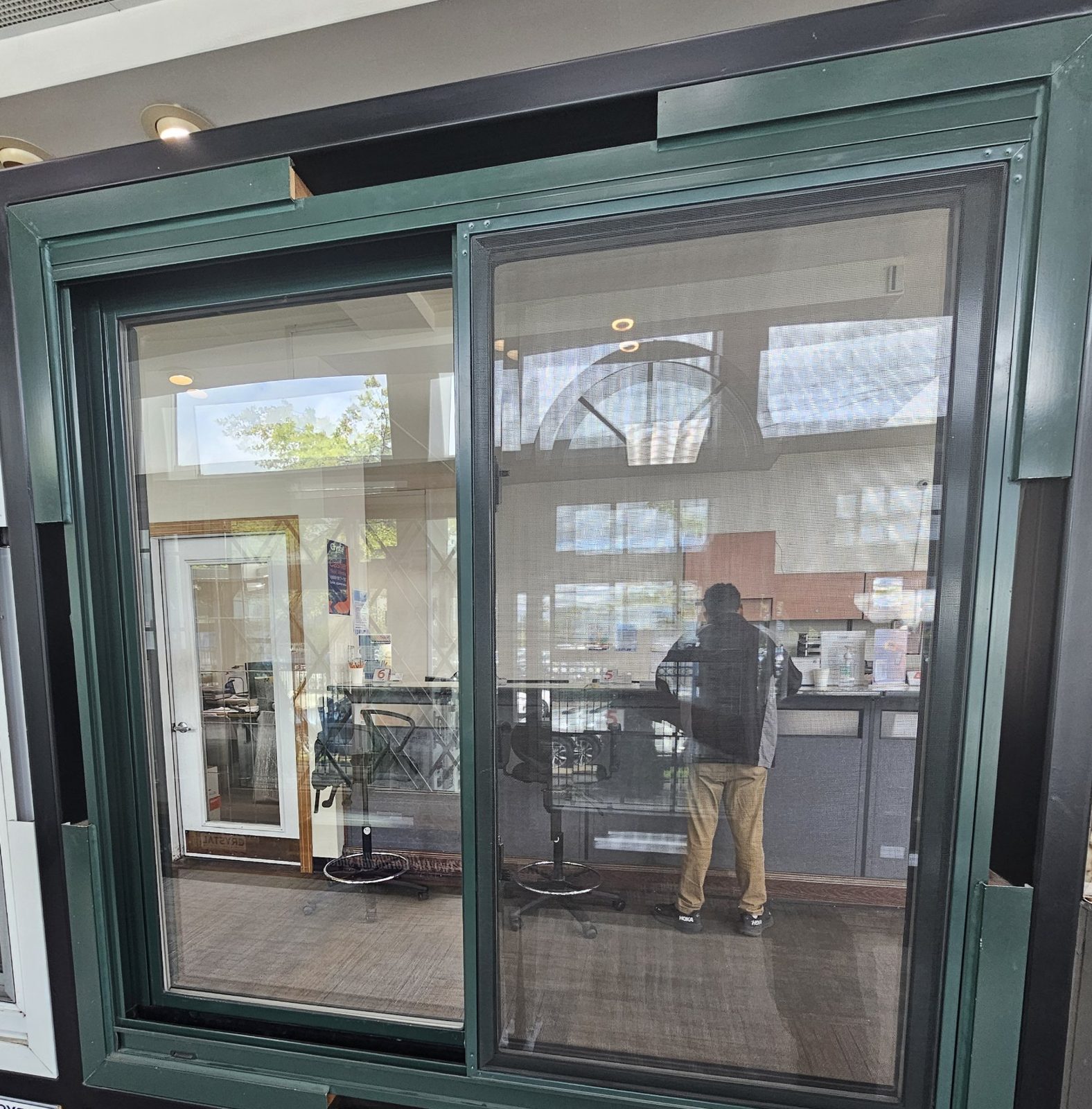 Crystal Series 2300 two-lite horizontal sliding window sample in a green powder-coat finish with the insect screen on the sliding lite