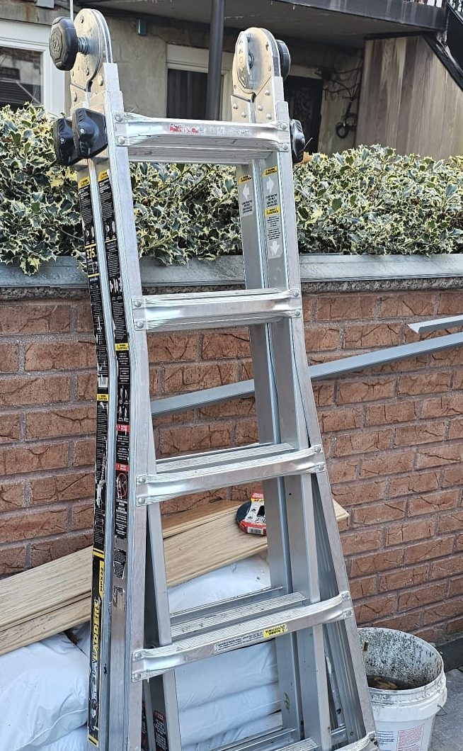 Aluminum multi-position Gorilla ladder folded in its A-frame position, with locking hinges at the top and telescoping side rails